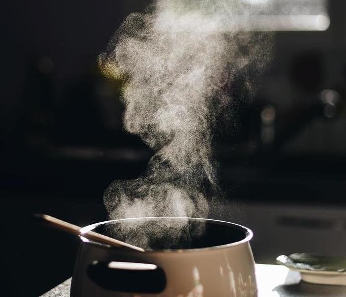 Smoke coming from pot on kitchen stove