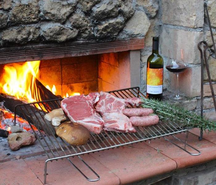 meat and wine by outdoor fire
